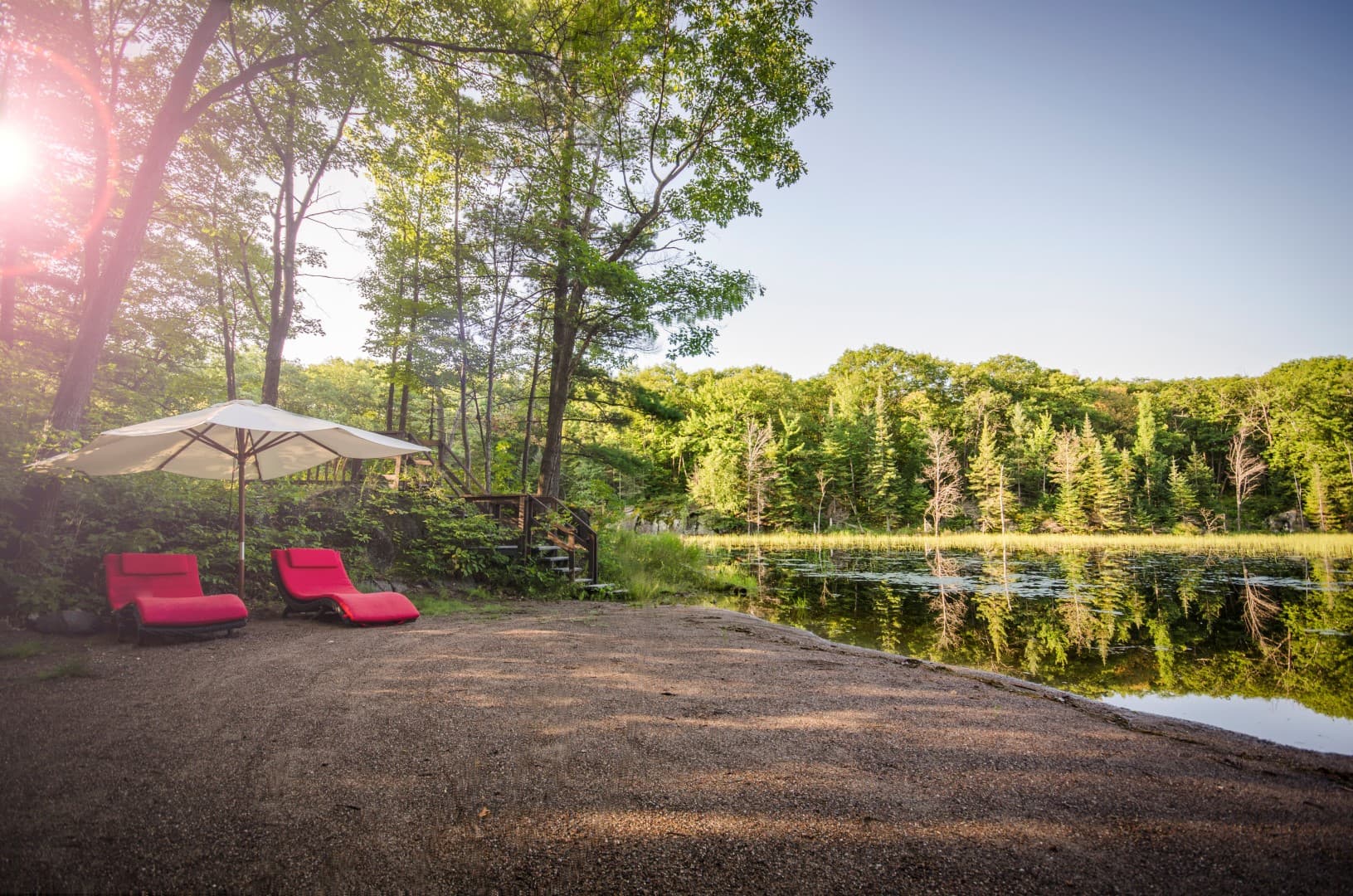 Loungers and umbrella at the private beach on Storyland Lake